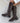 Brown stretch boots worn with a view of both buckles
